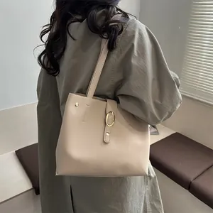 Minimalist beige leather tote bag for women with gold buckle and smooth finish