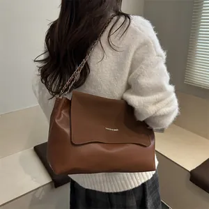 Retro brown faux leather tote bag with chain strap and letter print shown on model