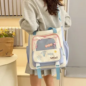 Student canvas tote bag with sky blue patchwork and cute embroidery displayed on model