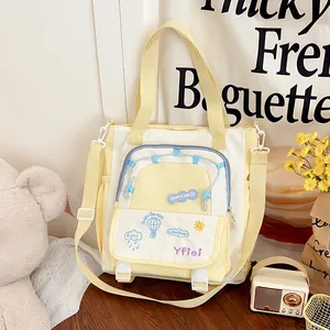 Detail of canvas tote bag with contrast yellow stitching and cartoon cloud embroidery