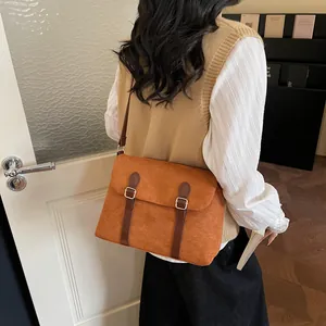 Brown frosted leather messenger bag with gold buckles for minimalist commuting style