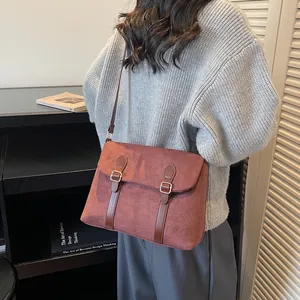 Large brick red matte messenger bag for women with brown buckles for stylish commuting