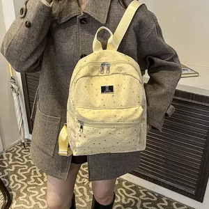 Yellow backpack with silver star print, large capacity for commuting and travel
