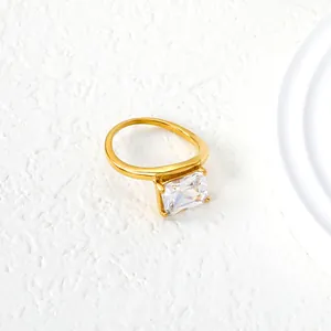 Minimalist gold stainless steel ring with rectangle cut zirconia stone in 4-prong setting