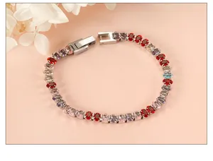 Close-up of multicolor oval-cut gemstones tennis bracelet with silver metal clasp