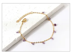 Detail of 18k gold plated bracelet featuring purple teardrop zircon and lobster clasp