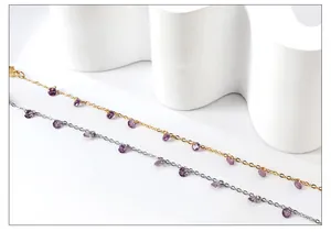 Detail of 18k gold and silver bracelets with teardrop purple crystal stones