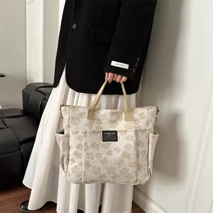 Minimalist beige floral tote bag with large capacity and multi-pocket design shown by model
