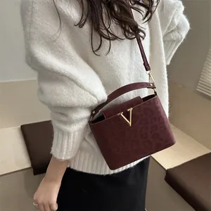 Burgundy leopard print handbag with metallic V-logo and adjustable crossbody strap