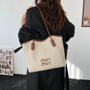 Retro oversized woven tote bag with brown leather handles and MIN MIN logo on model