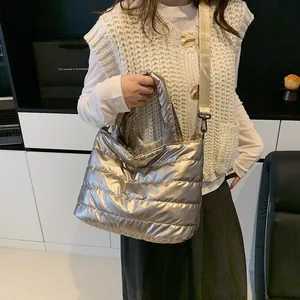 Champagne gold quilted puffer handbag with metallic finish and wide shoulder strap