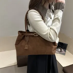 Brown faux suede tote bag with top handles and decorative buckle for women's daily commute