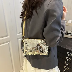 Elegant silver sequin crossbody bag with gold leather strap for trendy evening styling