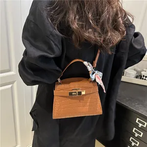 Brown crocodile pattern Kelly handbag with silk scarf handle and metal turn-lock