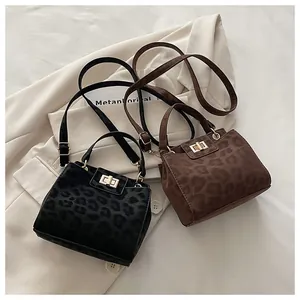 Detailed view of leopard print bucket bags with gold metal locks and adjustable straps