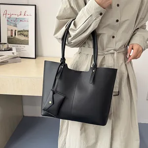French style black leather tote bag with long shoulder straps and small pendant pouch