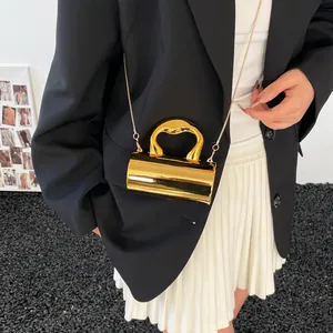 Glossy gold mini cylindrical chain bag with unique wavy top handle and metallic finish