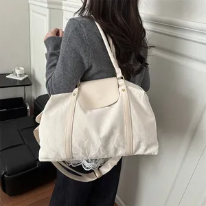 Large cream travel tote bag with shoulder strap and embossed fashion logo for women