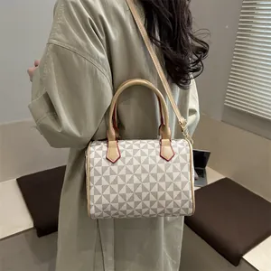 Boston style handbag with geometric triangle pattern and light camel leather straps