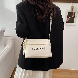 Minimalist beige corduroy tote bag with TOTE BAG embroidery and chic rope charm accessory