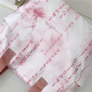Detail of artistic calligraphy and pink splash ink pattern on canvas tote bag fabric
