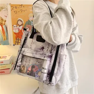 Detail of a white crossbody itabag with black calligraphy and a transparent PVC window