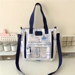 Detail of canvas tote bag showing Chinese calligraphy print and transparent card pocket