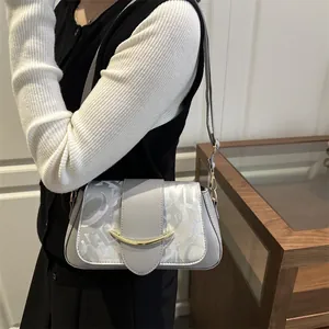 Minimalist light gray leather shoulder bag with gold hardware and logo pattern print