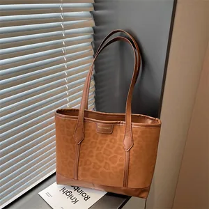 Brown leopard print suede tote bag with leather handles and fashion logo on front