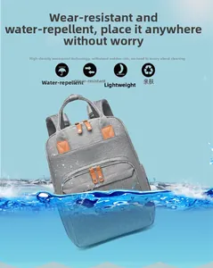 Waterproof and wear-resistant grey diaper backpack shown splashing in clear blue water