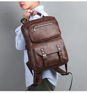 Detail of vintage brown leather backpack for men with USB port and multiple pockets