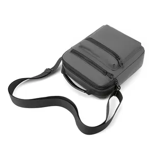 Macro view of dark grey waterproof oxford cross body bag with multiple zipper pockets