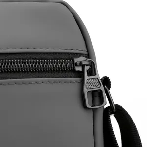 Close-up of waterproof Oxford fabric and premium metal zipper on men's shoulder bag