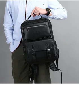Detail of black leather backpack with USB port and dual front pockets on male model