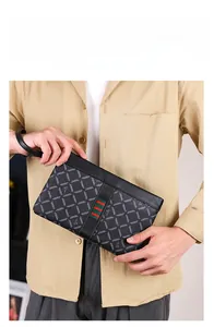 Detail of men's business clutch bag with geometric grid pattern and red-green stripe detail