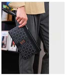 Detailed view of men's business clutch bag featuring green and red web stripe and wrist strap