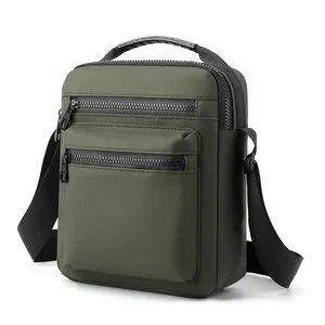 Close-up of olive green crossbody bag showing water-resistant texture and zipper details