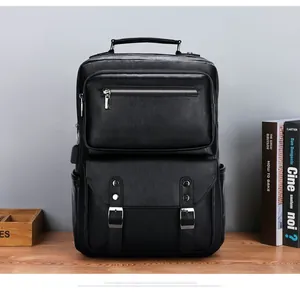 Close-up of black pebbled leather texture and silver buckle detail on business backpack
