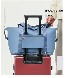 Detail view of a blue travel bag with a luggage sleeve attached to a suitcase handle