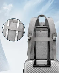 Close-up of the luggage strap on a gray diaper backpack attached to a suitcase handle