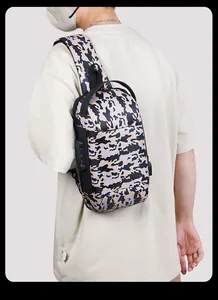 Detail of camouflage sling bag showing the secure three-digit combination anti-theft lock