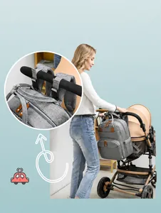 Detail showing the gray diaper bag's stroller hook design for easy attachment to travel strollers