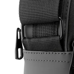 Close-up of durable high-density nylon webbing and matte waterproof fabric on black crossbody bag