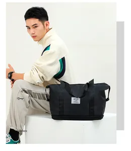 Detail of black nylon travel bag with waterproof bottom compartment and white brand patch