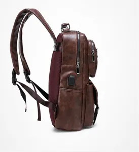 Brown leather laptop backpack side view featuring external USB port and breathable mesh padding