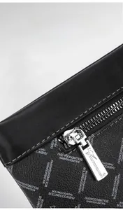 Close-up of gunmetal zipper and printed leather detail on a men's business clutch bag