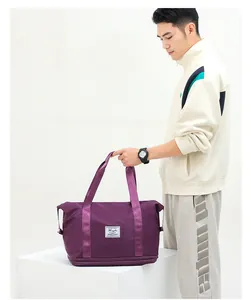 Detail of purple waterproof travel bag with expandable bottom layer and woven brand label