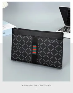 Detail of men's business clutch bag with lychee texture and red-green stripe on office desk