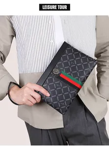 Detail of black leather clutch with checkered pattern, iconic stripes and lion head emblem
