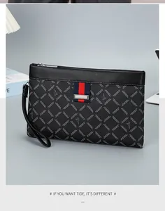 Detail of men's leather clutch bag with geometric pattern and red-blue ribbon accent